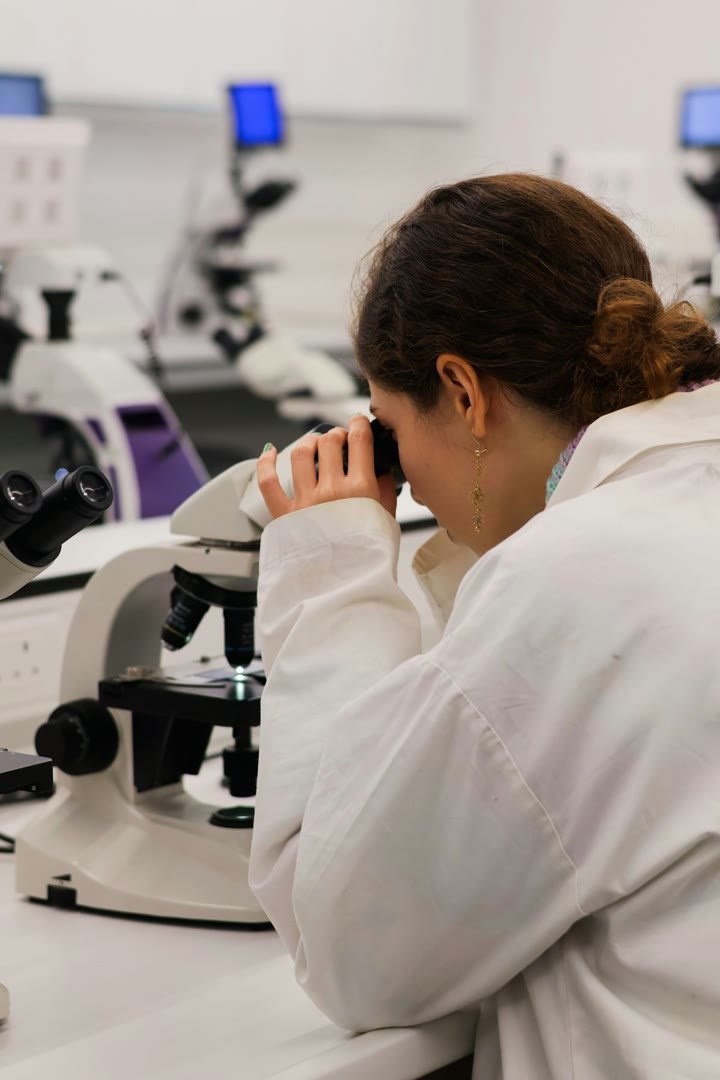 A scientist working at a microscope in a research laboratory
